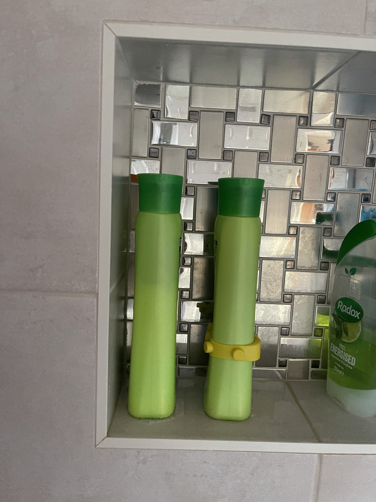 Photo of two similar bottles, one with a Band-it band in yellow with cylinder shapes.