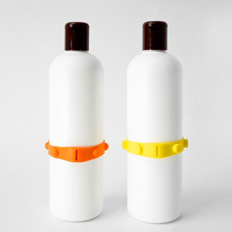 A photo of two bottles with different band-it bands applied