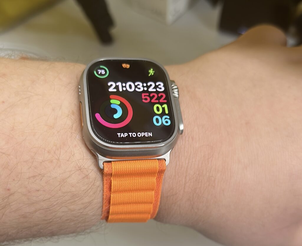 Apple Watch Ultra with Orange Alpine Band on a wrist